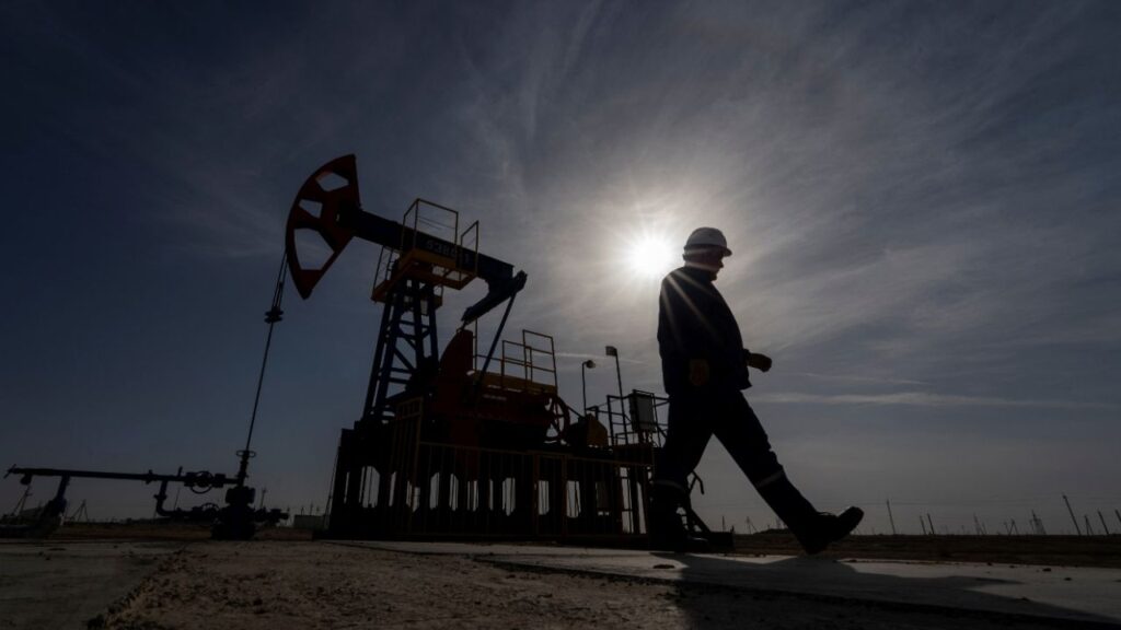 An oil and gas industry worker walks during operations of a drilling rig at Zhetybay field in the Mangystau region, Kazakhstan, November 13, 2023. (Reuters/Turar Kazangapov)