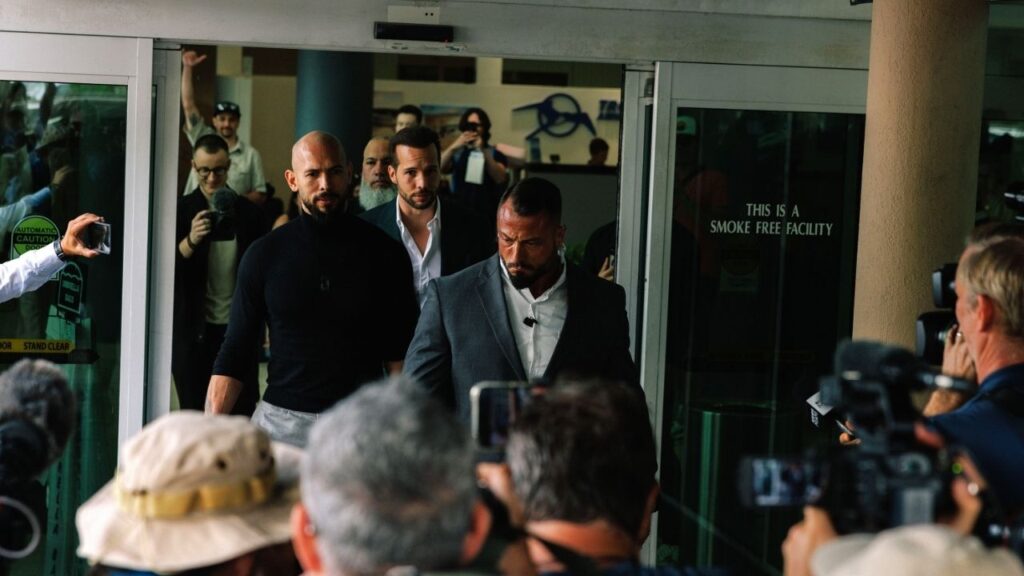 Andrew Tate, left in black, and his brother Tristan Tate, center rear, arrive at Fort Lauderdale-Hollywood International Airport in Florida on Feb. 27, 2025. After the Tate brothers, prominent leaders of the so-called manosphere, were arrested in Miami on July 18, 2026, many of their onetime allies on the American right pulled back support. (James Jackman/The New York Times)