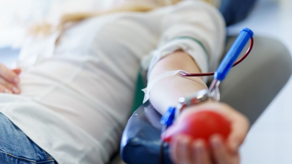 Asset id: 715167073 young caucasian woman with toy heart in the hand donates blood for saving lives and medical research in some hospital at day time