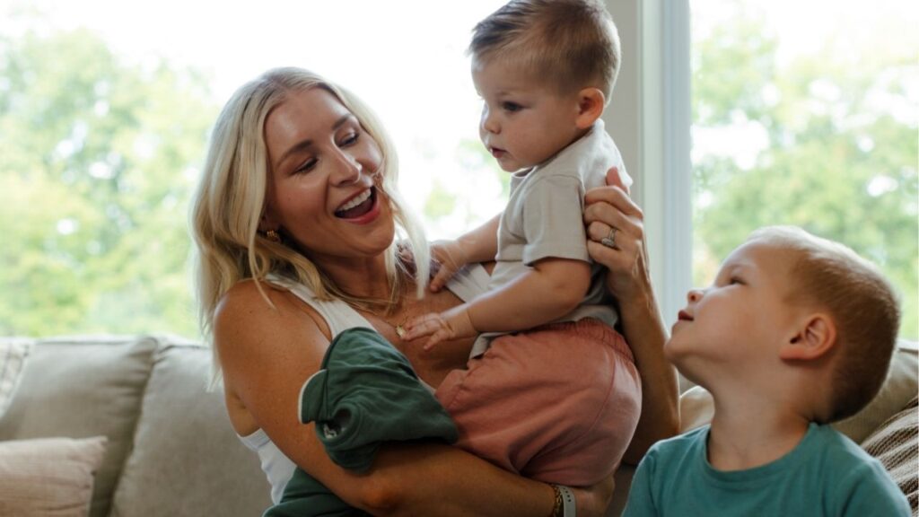 — EMBARGO: NO ELECTRONIC DISTRIBUTION, WEB POSTING OR STREET SALES BEFORE 5:01 A.M. ET ON SATURDAY, JULY 11, 2026. NO EXCEPTIONS FOR ANY REASONS — Mallory Baska at home with her sons in Parkville, Mo., on July 9, 2026. Baska, who owns a financial education services business, is opening a Trump account for her youngest son, who was born in 2025 and qualifies for the $1,000 government seed deposit. (Chase Castor/The New York Times)