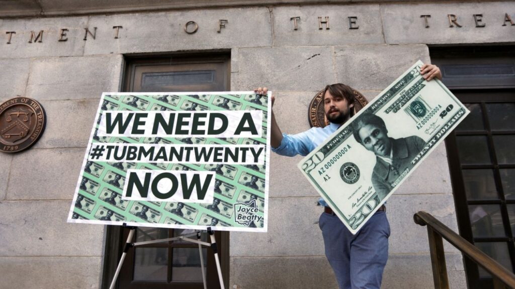 Capitol Hill staff member places signs before a news conference by House Majority Leader Steny Hoyer (D-MD) on Treasury Secretary Steve Mnuchin's decision to indefinitely delay putting famous abolitionist Harriet Tubman on the new $20 bill, on the steps of the Treasury Department in Washington, U.S., June 27, 2019. (Reuters File)