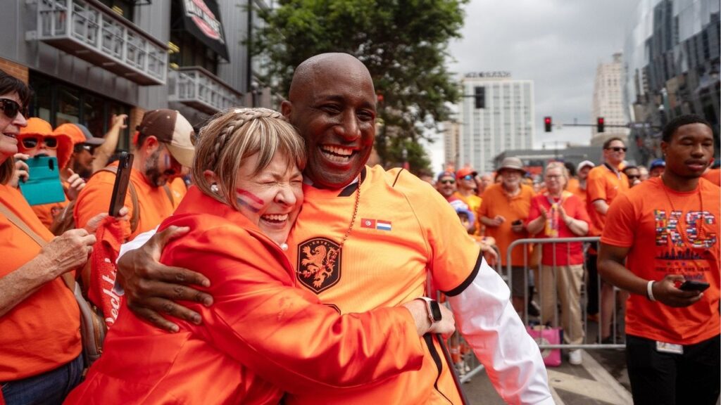 A soccer fan embraces Kansas City Mayor Quinton Lucas, right, before a Netherlands World Cup soccer team march in Kansas City, Mo., on June 25, 2026. Over the past month, the world’s soccer fans have taken to Kansas City, the smallest American host of these World Cup games, succumbing to the charms of its Midwesterners, its artisan barbecue, and its long, but largely overlooked, history with the “beautiful game.” (Christopher Smith/The New York Times)