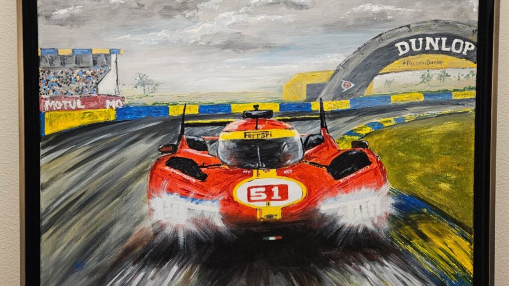 Image of a painting featuring a classic red Ferrari racing on a track with its lights on beneath white clouds at dusk