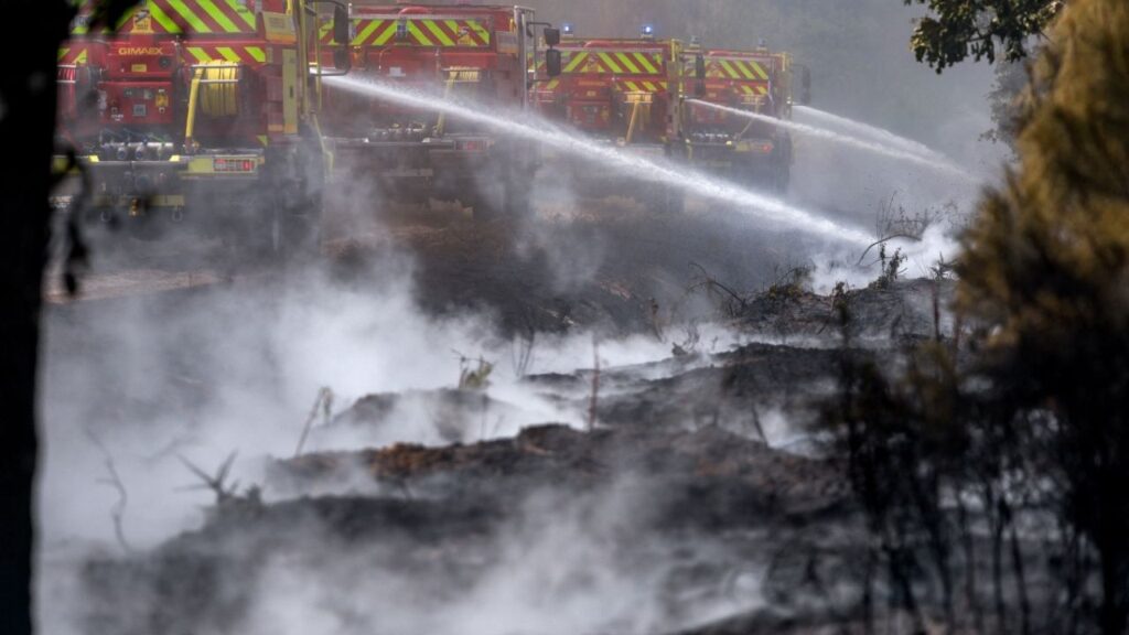 Firefighters work to battle wildfires amid drought conditions following a heatwave and water shortages across much of France, in Marcheprime, Gironde department, France, July 27, 2026. (Reuters/Florion Goga)