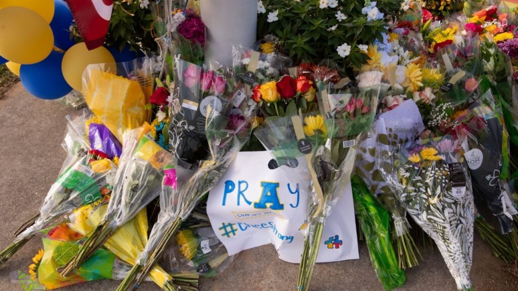 Flowers left at a makeshift memorial outside Apalachee High School in Winder, Ga., after a mass shooting left two students and two teachers dead, Sept. 5, 2024. On the day after a deadly mass shooting in the United States, when media coverage and internet searches reach their peak, traffic fatalities appear to spike, a new study has found. (Amanda Kathleen Greene/The New York Times)