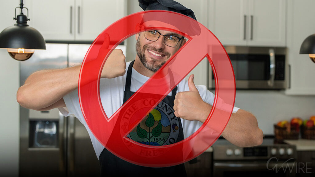 A person cooking at their in-home kitchen. With a no sign.