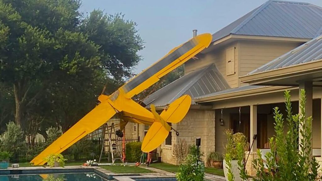 In an image provided by the Fulshear Simonton Fire Department, a small plane after it crashed into a house in Fulshear, Texas, west of Houston, on Monday morning, July 20, 2026. The pilot, who was identified as Alan Gillis, was the only person aboard the plane when it crashed, officials said. (Fulshear Simonton Fire Department via The New York Times)
