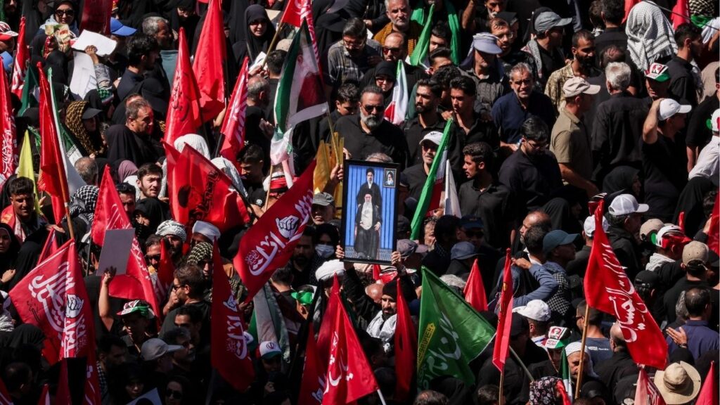 A man raises a picture featuring Iran's Supreme Leader Mojtaba Khamenei and Iran’s late Supreme Leader Ayatollah Ali Khamenei, as mourners gather on the day of the burial of Ayatollah Ali Khamenei, who was killed on February 28 in Israeli and U.S. airstrikes, in Mashhad, Iran, July 9, 2026. Reuters/Alkis Konstantinidis