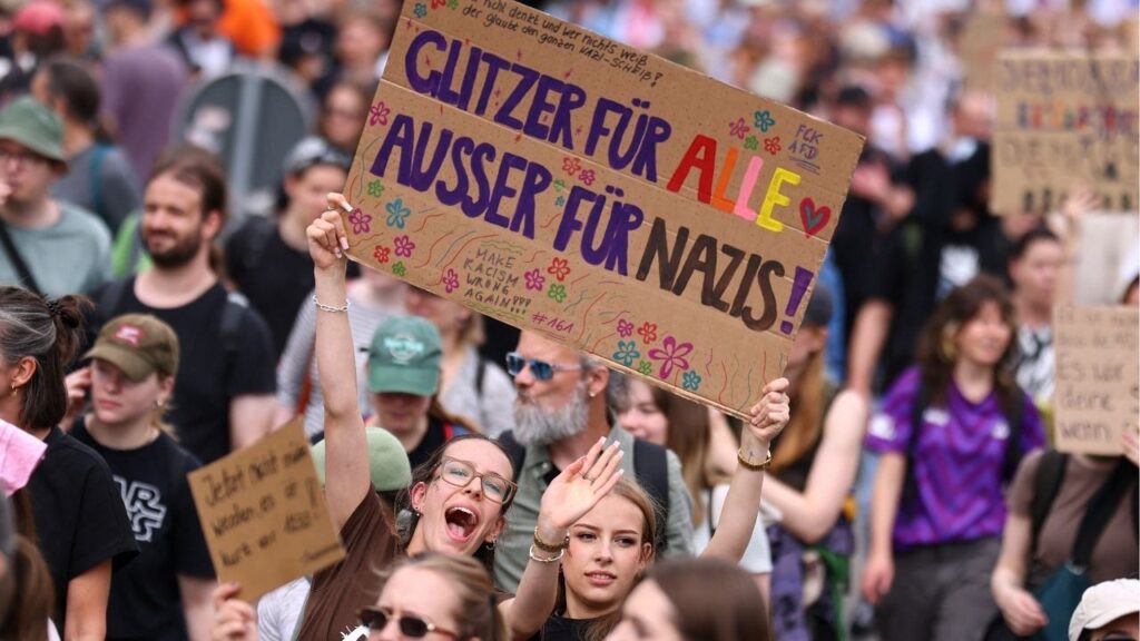 People hold a sign that reads: "Glitter for everyone, except for Nazis" during a protest against a two-day party convention of Germany's far-right Alternative for Germany (AfD) party, in Erfurt, Germany, July 4, 2026. Reuters/Christian Man
