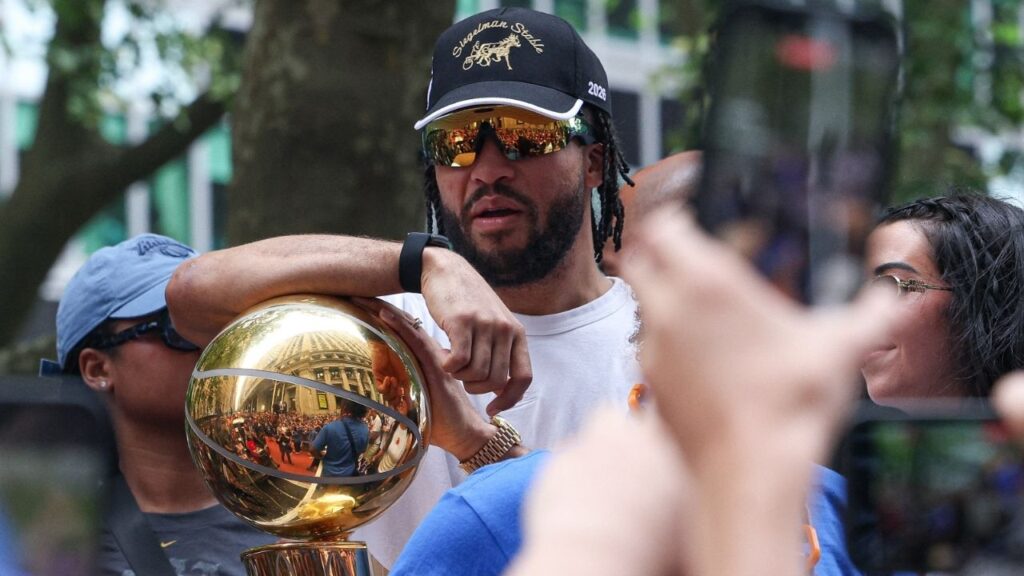 Jun 18, 2026; New York, NY, USA; New York Knicks guard Jalen Brunson (11) celebrates while holding the Larry O'Brien Championship Trophy during the Knicks ticker-tape parade and celebration on Broadway in downtown Manhattan. Mandatory Credit: Vincent Carchietta-Imagn Images