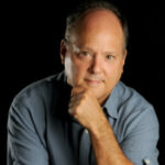 Portrait of journalist Len Silverstein with his hand on his chin in a "thinking" pose
