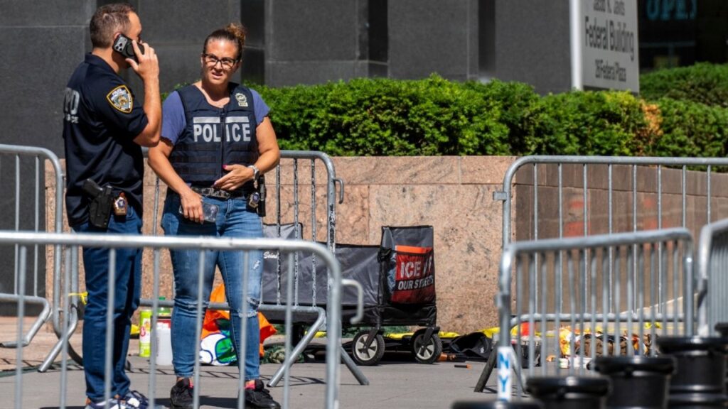 Law enforcement investigators outside of 26 Federal Plaza in New York, on Monday, 20, 2026. A man was taken into custody on Monday after the police said he set a fire, ignited fireworks and waved a gun outside the federal building in Manhattan that houses federal immigration courts. (Adam Gray/The New York Times)
