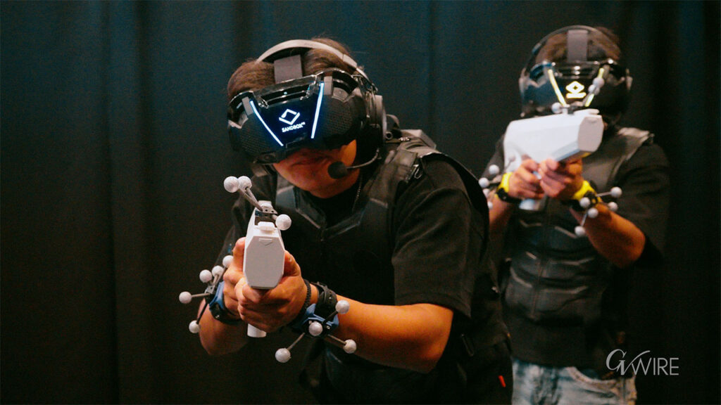 Guests use motion-capture headsets, haptic vests and handheld controllers during a virtual reality experience at Sandbox VR in Fresno. (Eric Martinez/GV Wire)