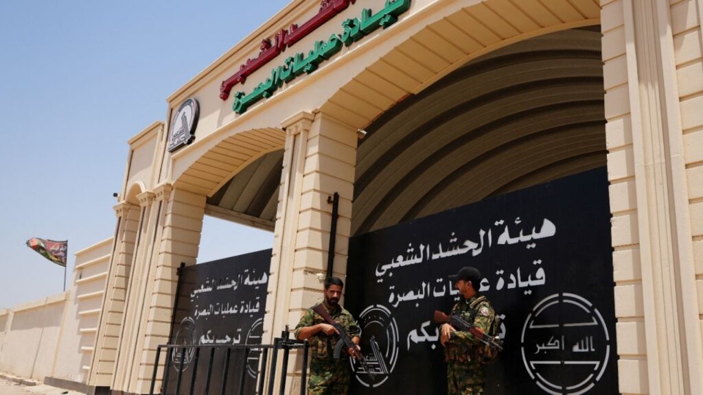 Members of Iraq's Popular Mobilization Forces (PMF) stand guard outside the Basra Operations Command headquarters, following airstrikes that the PMF said were carried out by U.S. and Saudi forces in Basra, Iraq July 29, 2026. REUTERS/Essam Al-Sudani