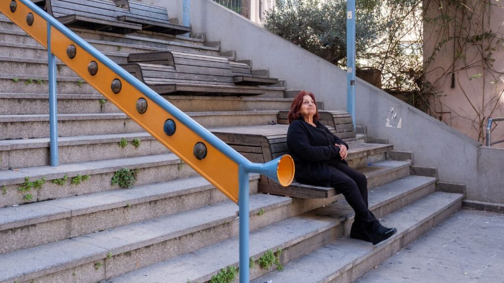 Resident Samira al Ahmar, 72, lives at the top of Vendome stairs in Beirut, Feb. 18, 2026. Minecraft is helping kids redesign their cities and In 55 countries, the popular video game has been used to engage children in the process of urban design. (Natalie Naccache/The New York Times)