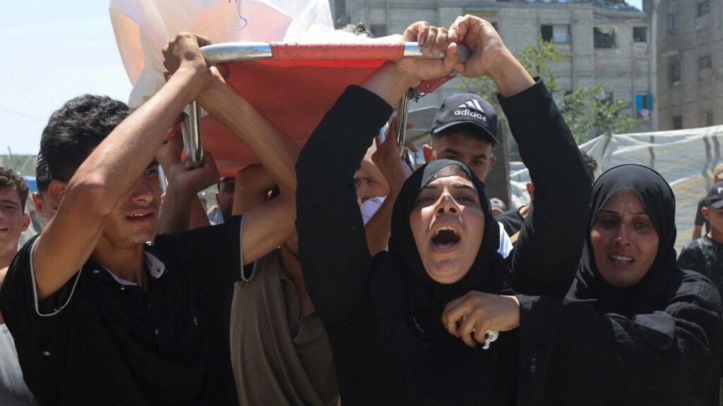 Mother of Palestinian child Muataz Abu Shaar, who was killed by Israeli fire, according to medics, and other mourners carry his body during his funeral in Khan Younis, in the southern Gaza Strip, July 14, 2026. (Reuters/Ramadan Abed)