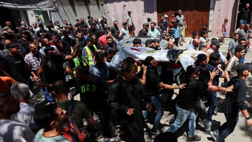 Mourners carry the body of Palestinian man Mohammad al-Waheidi, who worked for the Egyptian Relief Committee and was killed in an Israeli strike on Tuesday, during his funeral, in Gaza City, July 8, 2026. (Reuters/Dawoud Abu Alkas)