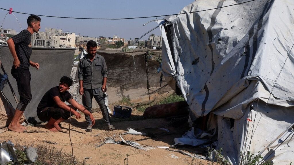 Palestinians inspect the site of an Israeli strike on a tent in Khan Younis, in the southern Gaza Strip, July 8, 2026. (Reuters/Haseeb Alwazeer)