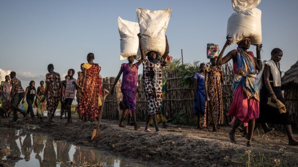 People carry away supplies dropped by a World Food Program plane in Akobo, South Sudan, May 18, 2026. .in a significant reversal of public opinion, people in many countries around the world now view China more positively than they do the United States. (Ed Ram/The New York Times)