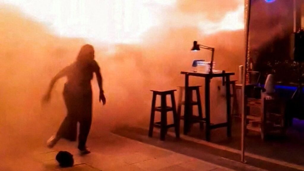 People run as flames rise at a pub in Bangkok, Thailand, in this screengrab taken from a social media video released on July 13, 2026. txng.di.kwa.deim.hi.di via Facebook/via REUTERS