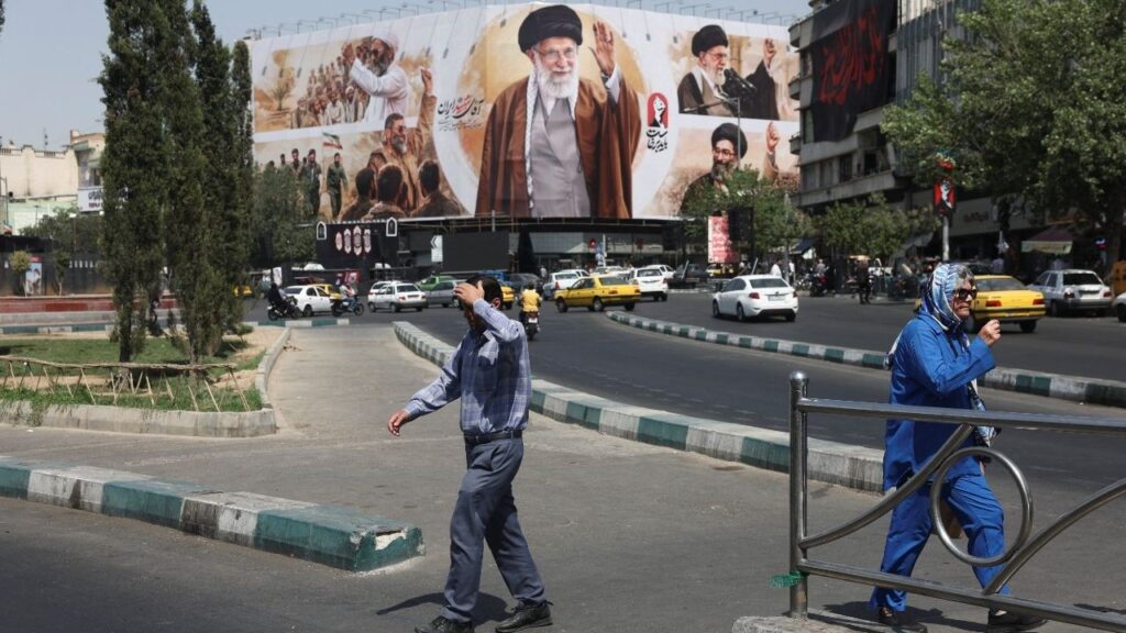 People walk past a billboard featuring images of Iran's late Supreme Leader Ayatollah Ali Khamenei in Tehran, Iran, July 13, 2026. Majid Asgaripour/WANA (West Asia News Agency) via Reuters