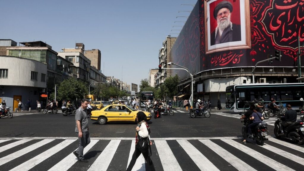 People walk past a billboard with an image of Iran's late Supreme Leader Ayatollah Ali Khamenei in Tehran, Iran, July 13, 2026. Majid Asgaripour/WANA (West Asia News Agency) via Reuters