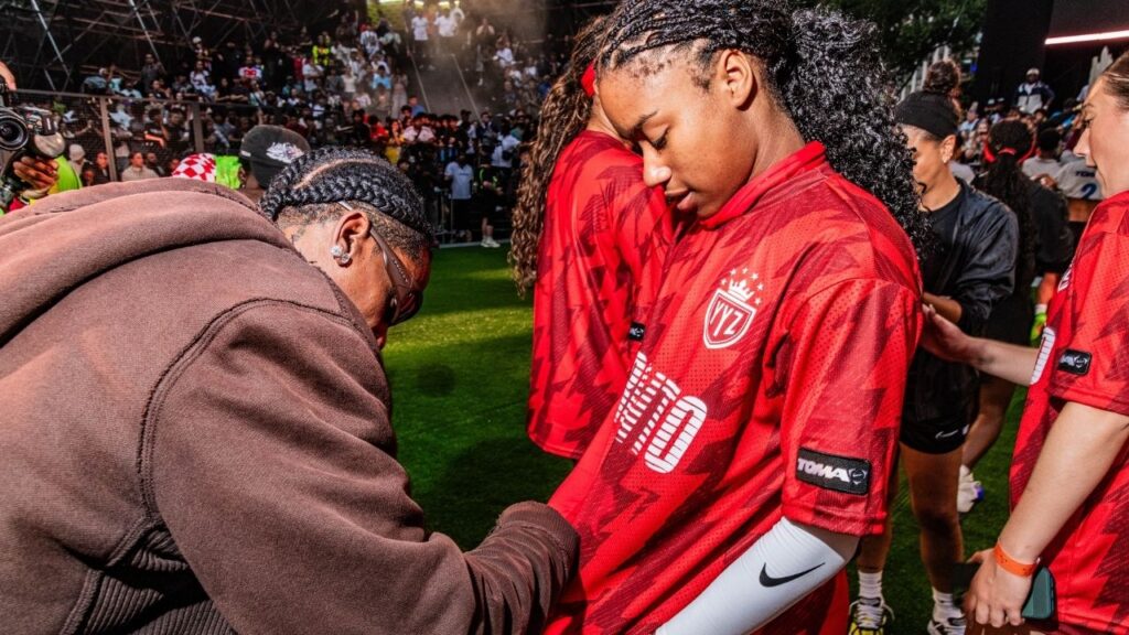 Rapper Travis Scott signs a player's shirt at a Nike Toma soccer event in New York on June 27, 2026. As World Cup matches take place across the United States, Nike and Adidas, the two largest sportswear companies in the world, are spending millions of dollars in a duel over the future of soccer in America. (Emma Rose Milligan/The New York Times)