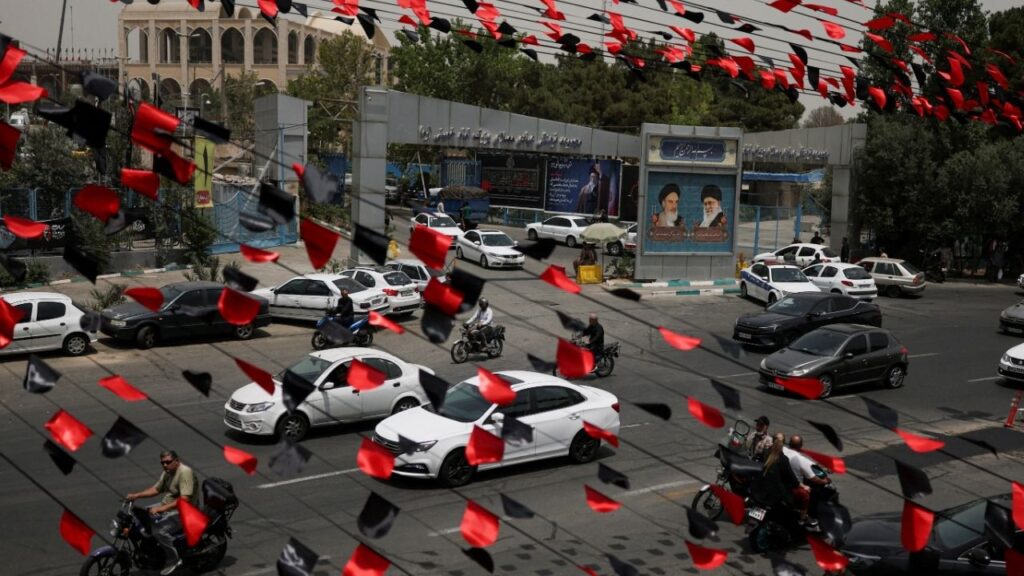 Red and black pennants hang above a street as vehicles pass by during preparations for a farewell ceremony for Iran's late Supreme Leader Ayatollah Ali Khamenei who was killed on February 28 in Israeli and U.S. airstrikes, otside the Imam Khomeini Grand Mosalla, in Tehran, Iran July 2, 2026. REUTERS/Mohammed Salem