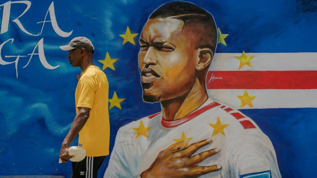 A mural showing a player with Cape Verde’s national team — the Blue Sharks — in Praia, the capital. The player is facing left with his hand over his heart,