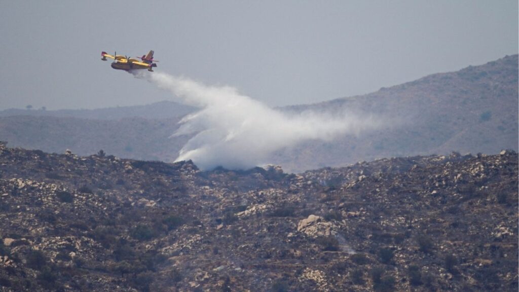 An aircraft drops water above wildfires affecting Almeria province, in Los Gallardos, Spain, July 11, 2026. Reuters/Ana Beltran