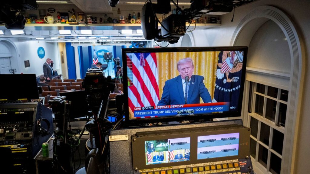 Image of President Trump speaking shown on a video monitor inside the White House briefing room