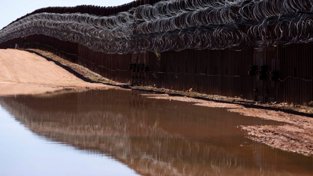 The U.S.-Mexico border fence is reflected in a puddle of water in Naco, Arizona, U.S., April 20, 2025. (Reuters File)
