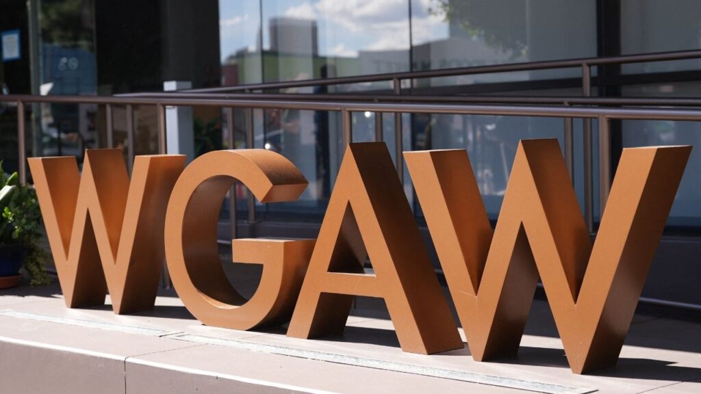 The Writers Guild of America West logo stands as Writers Guild staff take part in a strike outside the WGAW headquarters in Hollywood, Los Angeles, California, U.S., February 18, 2026. REUTERS/Arafat Barbakh