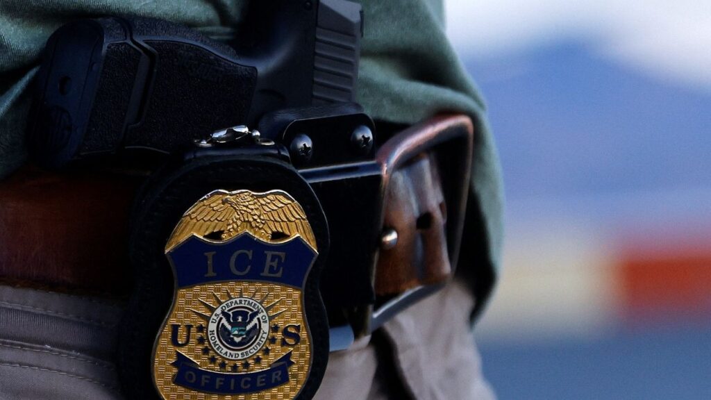 The badge of a U.S. Immigration and Customs Enforcement (ICE) agent is seen during an operation with migrants being transferred to a plane to be expelled under U.S. Title 42 from the United States to their country by U.S. Immigration and Customs Enforcement (ICE) agents and Border Patrol agents, at the airport in El Paso, Texas, U.S., May 10, 2023. (Reuters/Jose Luis Gonzalez)