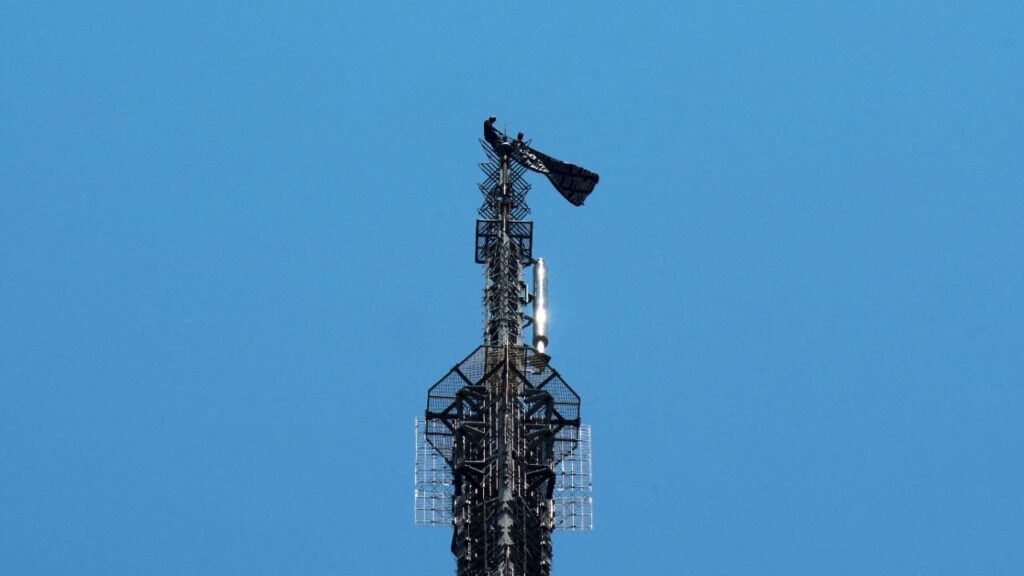 Two people display a banner as they stage a protest atop the Empire State Building in the Manhattan borough of New York, U.S., July 1, 2026. REUTERS/Adam Gray