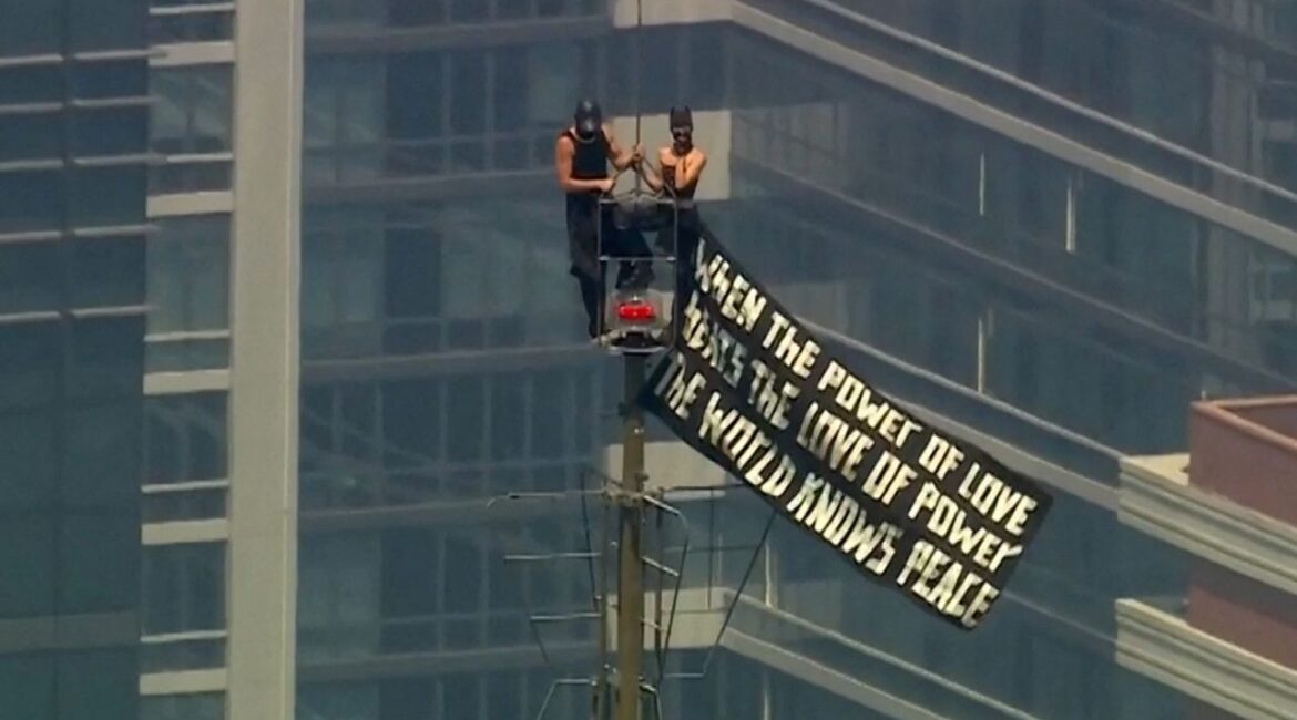Two people display a banner atop the Empire State Building in the Manhattan borough of New York, U.S., July 1, 2026 in a still image from video. ABC Affiliate WABC/Handout via REUTERS