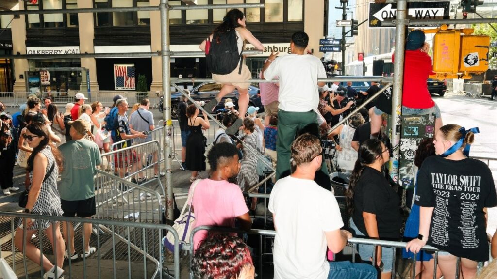Taylor Swift fans near Madison Square Garden hope to catch a glimpse of the pop star during her wedding to Travis Kelce in New York on July 3, 2026. It was the most public setting one could imagine, and yet the most private celebrity wedding, in recent memory, of such a size, completely shrouded in secrecy. (Lanna Apisukh/The New York Times)