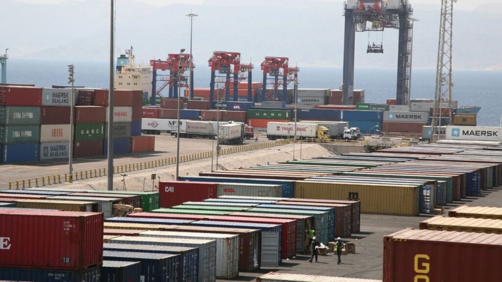 Workers walk in a shipping container area at the Port of Aqaba, 350 km (217 miles) south of Amman, September 18, 2011. (Reuters File)