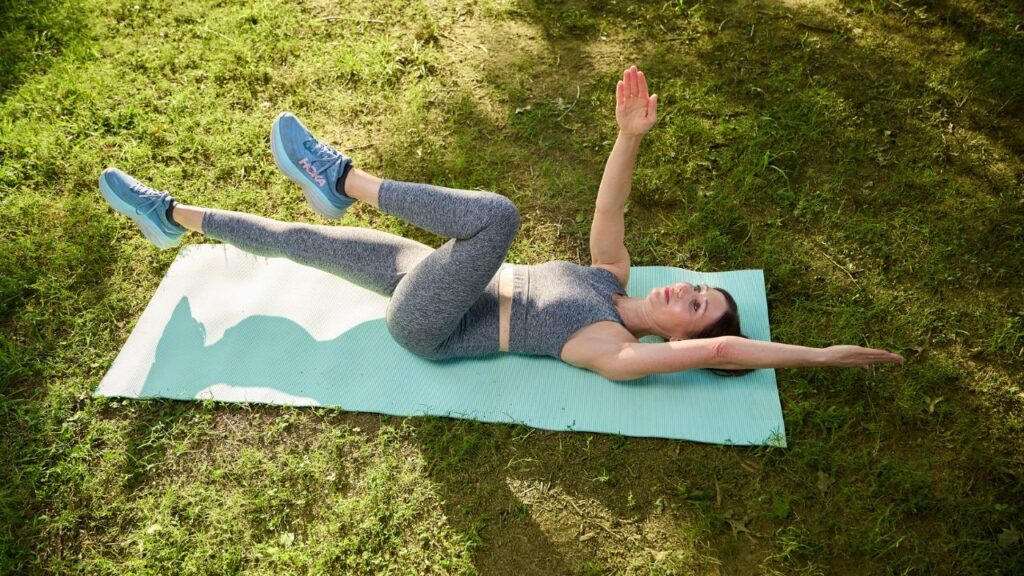 A woman performs dead bugs with diaphragmatic breathing at a park in Atlanta, on Aug. 12, 2026. Making time to practice good movement habits can keep you feeling limber and strong. (Bee Trofort/The New York Times)