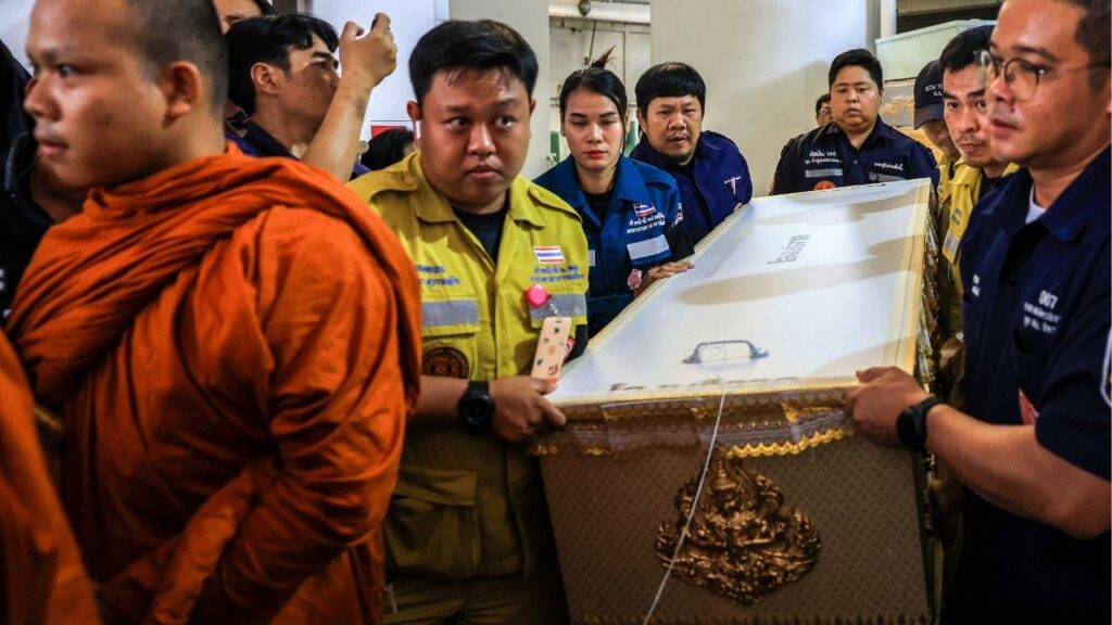 A Buddhist monk leads as workers move a coffin with the body of a victim killed in a deadly shooting at Debsirin Nonthaburi School, at Police General Hospital, in Bangkok, Thailand, August 8, 2026. REUTERS/Valeria Mongelli