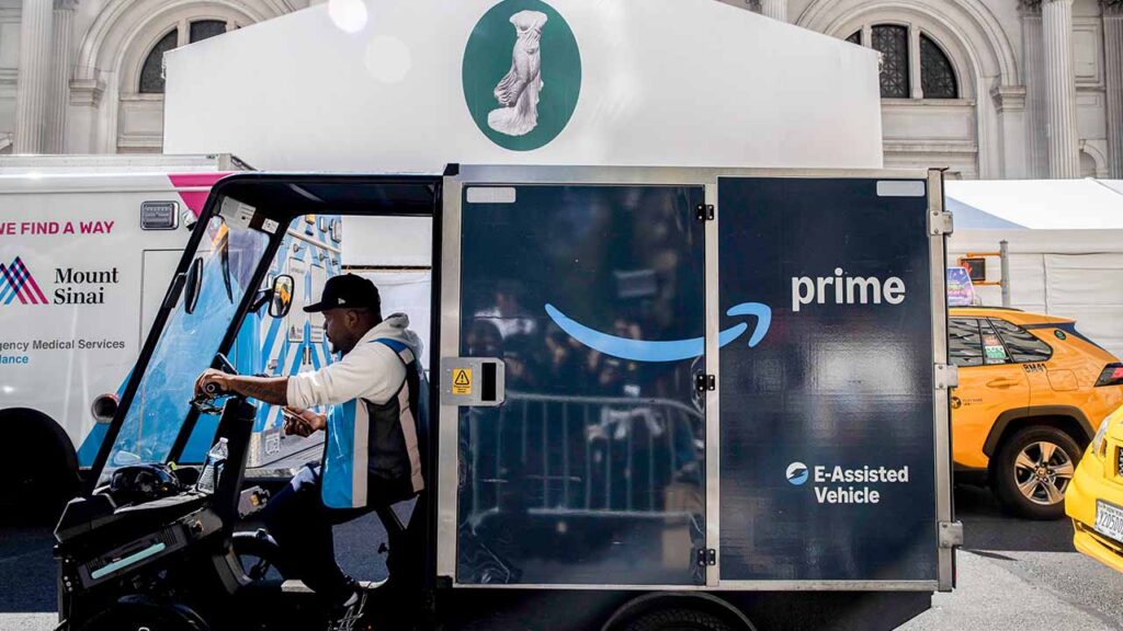 A worker in an Amazon delivery vehicle in Manhattan, May 4, 2026. Mayor Zohran Mamdani of New York wants major companies to hire employees directly rather than relying on contractors; the firms say that will raise prices and slow service. (Dave Sanders/The New York Times)