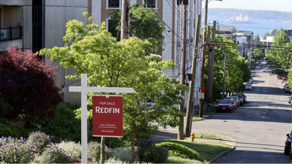 A "For Sale" sign is posted outside a residential home in the Queen Anne neighborhood of Seattle, Washington, U.S. May 14, 2021. (Reuters File)