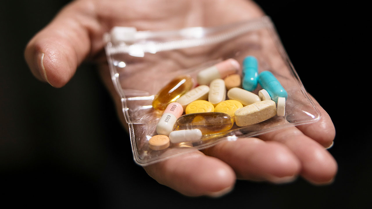 Tracy Atteberry, who has chronic granulomatous disease, a rare inherited immune disorder, displays a package of the pills he must take daily, at the National Institutes of Health in Bethesda, Md., Sept. 4, 2025. Gene therapies for rare diseases are frequently developed then discarded by drug companies because they cannot afford to produce the treatment for more patients. (Alyssa Schukar/The New York Times)
