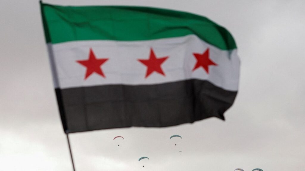 A flag flies in the wind at Ummayad Square in Damascus, Syria December 8, 2025. REUTERS/Yamam al Shaar