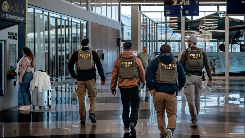 A group of federal immigration officers walk through O’Hare International Airport in Chicago on March 23, 2026. The Trump administration plans to spend millions of dollars equipping immigration officers with gloves that can deliver electric shocks. (Jamie Kelter Davis/The New York Times)
