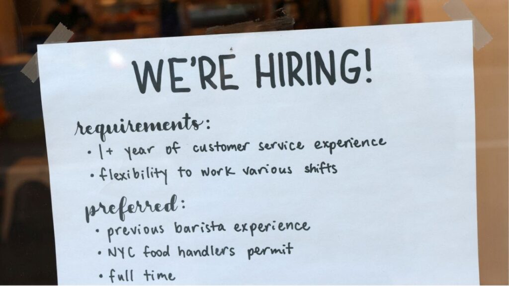 A hiring sign is seen in a cafe as the U.S. Labor Department released its July employment report, in Manhattan, New York City, U.S., August 5, 2022. (Reuters/Andrew Kelly)