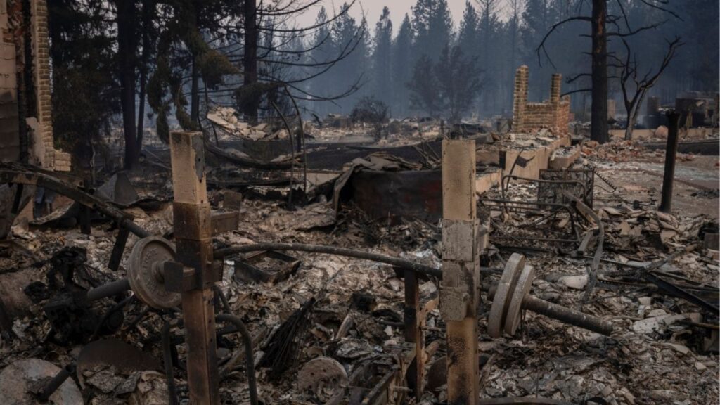 A melted weight set at a home destroyed by the Old Trails fire in Spokane, Wash., on Monday morning, Aug. 3, 2026. The authorities in Spokane County, Wash., arrested a man on Monday who they suspected of starting the Oil Trails fire, one of three fires that forced more than 65,000 people to evacuate over the weekend. (Loren Elliott/The New York Times)
