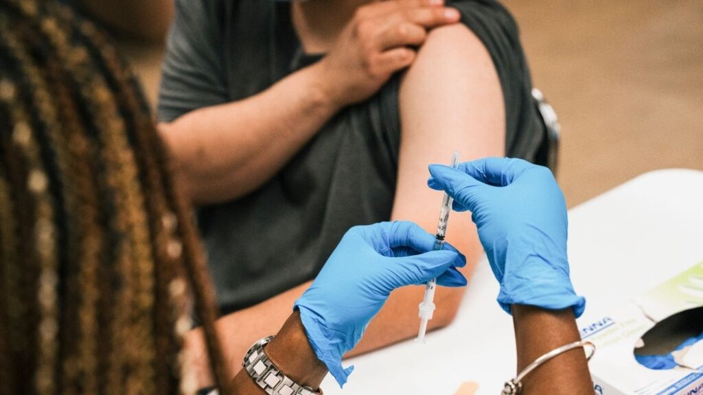 A registered nurse prepares the Covid booster in Maywood, Ill. on Sept. 13, 2022. The Food and Drug Administration approved updated Covid vaccines on Aug. 27, 2026, clearing the way for manufacturers to ship doses to pharmacies and doctors’ offices. (Jamie Kelter Davis/The New York Times)