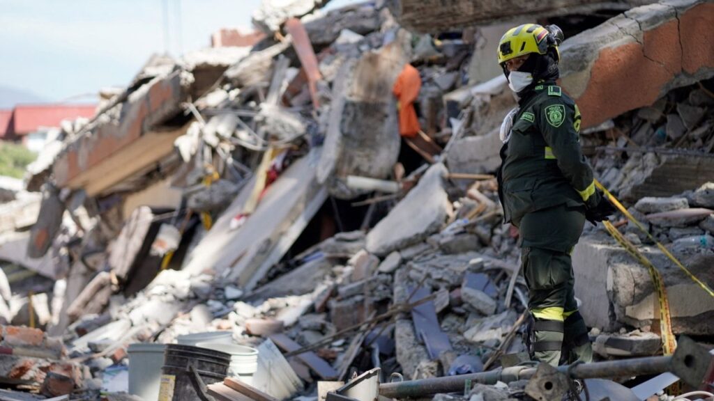 A rescuer stands amid rubble at the Torres de Limonar building in the aftermath of an earthquake, in Cali, Colombia, August 13, 2026. REUTERS/Sergio Acero