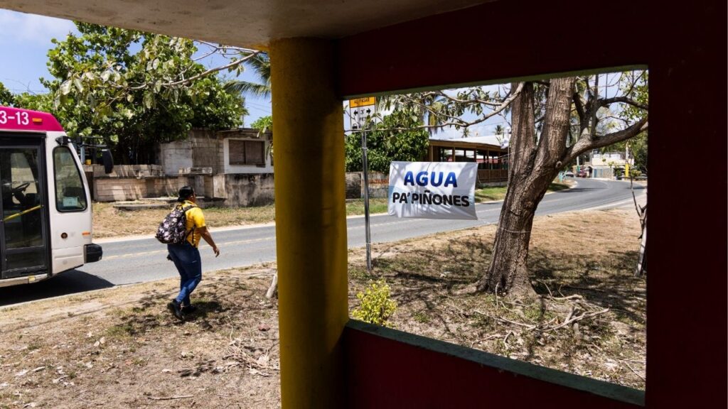 A sign that reads “Water for Piñones” next to one of the community’s main roads in Loíza, Puerto Rico, Aug. 4, 2026. The water crisis has put yet another spotlight on the government’s inability to provide basic services, deepening frustration among residents already plagued by regular power outages. (Erika P. Rodriguez/The New York Times)